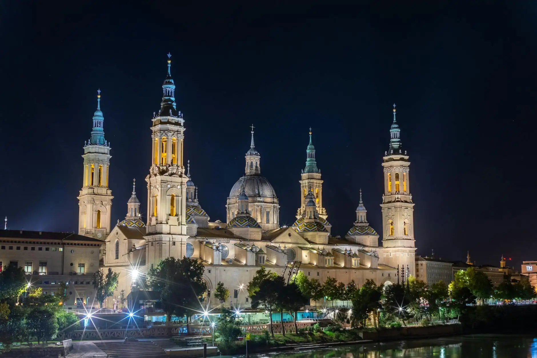 Stunning night view of Basilica of Our Lady of the Pillar in Zaragoza, Spain, beautifully illuminated.