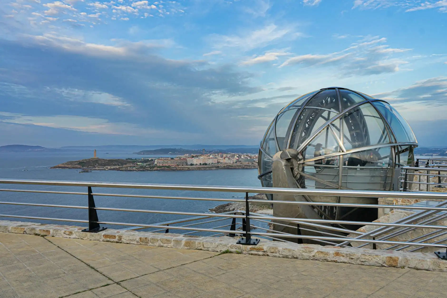 Steel structure overlooking the Torre de Hércules and coastal view in La Coruña, Spain.