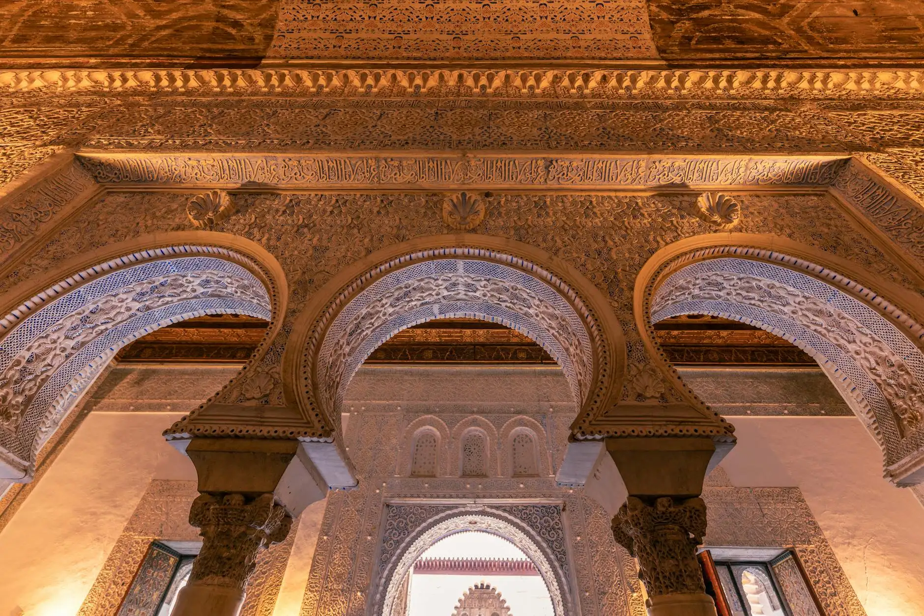 Stunning Islamic architectural details in Sevilla's historic palace, showcasing exquisite arches and carvings.